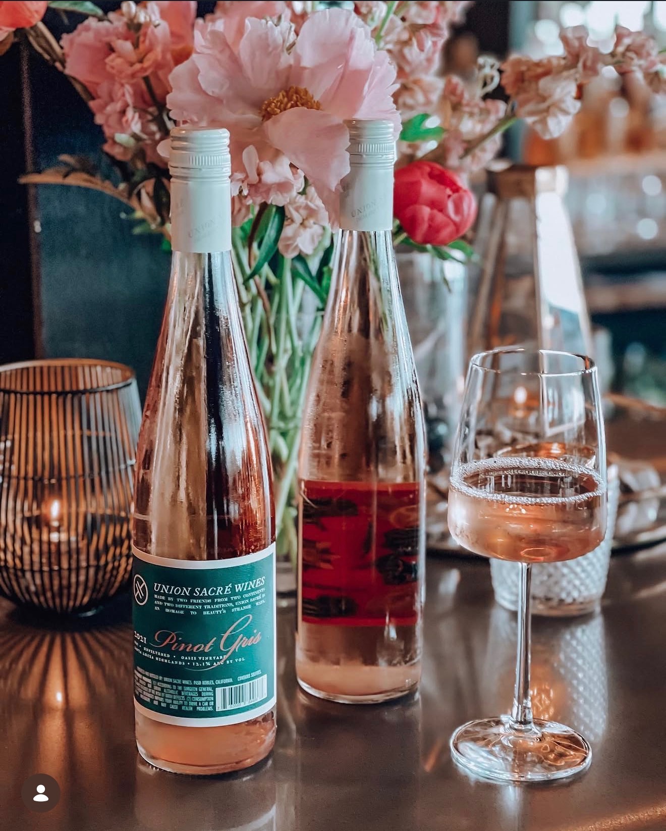 photo of champange bottles and a filled glass